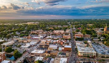 AI generated aerial view of downtown Naperville surrounded by buildings